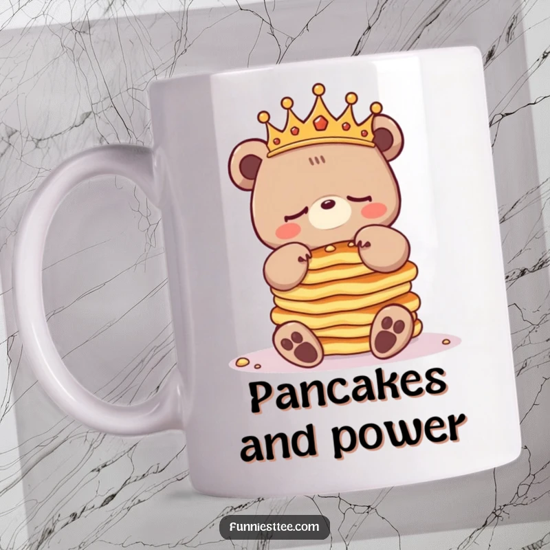 Funny sleepy bear mug with a crowned bear character struggling to balance a huge stack of pancakes, looking exhausted but regal.