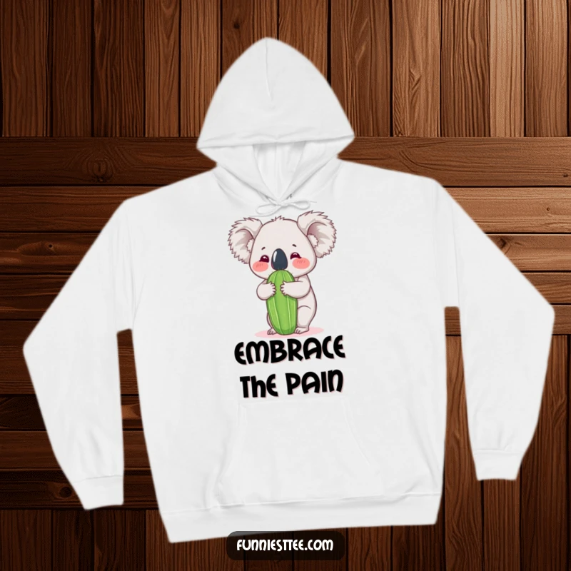 Funny koala hoodie depicting a fluffy koala enthusiastically hugging a tall, green cactus, expressing humorous and endearing affection.