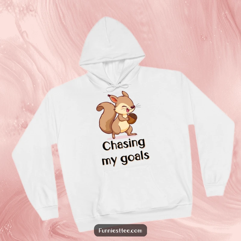 Funny Hoodie design: a determined squirrel with an oversized acorn is comically chasing its own tail in a circle.