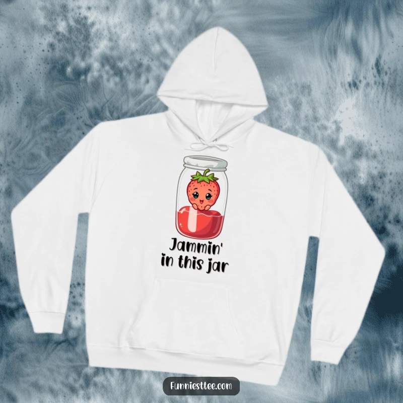 Funny hoodie depicting a cheerful strawberry character stuck in a jam jar, looking surprised, a warm and whimsical wearable art piece.