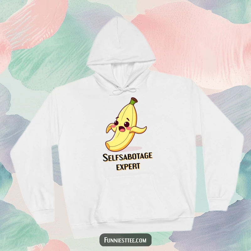Funny hoodie showing a surprised cartoon banana peel with a wide grin, comically falling after slipping on its own peel, pure comedy.