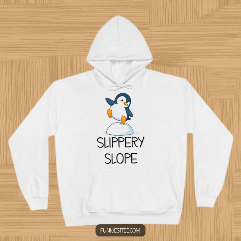 Funny Penguin Trip Hoodie: A penguin dramatically trips over a single icy pebble, a soft and warm funny apparel.