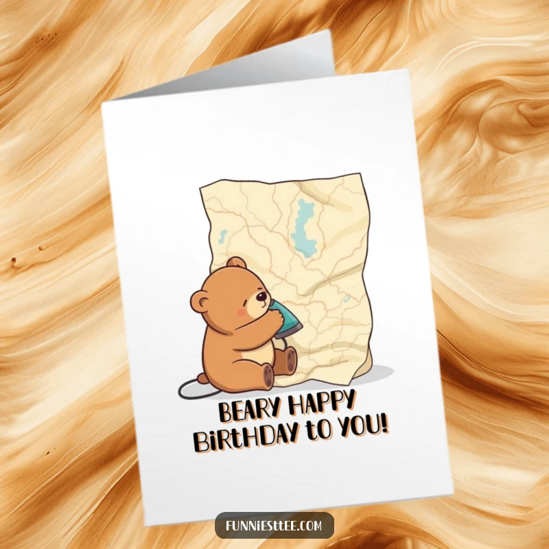 Funny Free Printable Birthday Card: A very sleepy bear struggles to iron out wrinkles on an enormous, crinkled map.