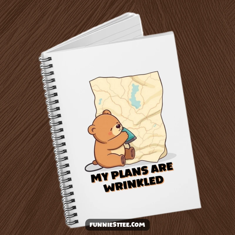 Funny notebook cover with a sleepy bear ironing a large map, perfect for jotting down ideas with a touch of sleepy charm.