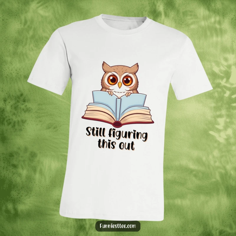 Funny owl t-shirt with wide eyes peeking from a large, open storybook, illustrating a whimsical and curious reading adventure.