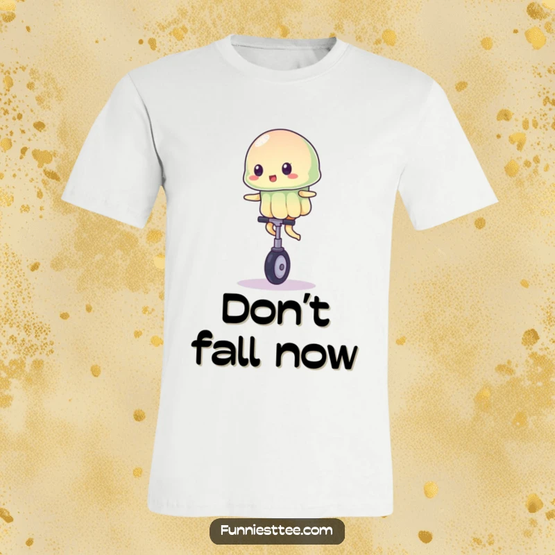 Funny t-shirt depicting a jiggly jelly character attempting to balance on a miniature unicycle, showcasing a comical circus stunt.