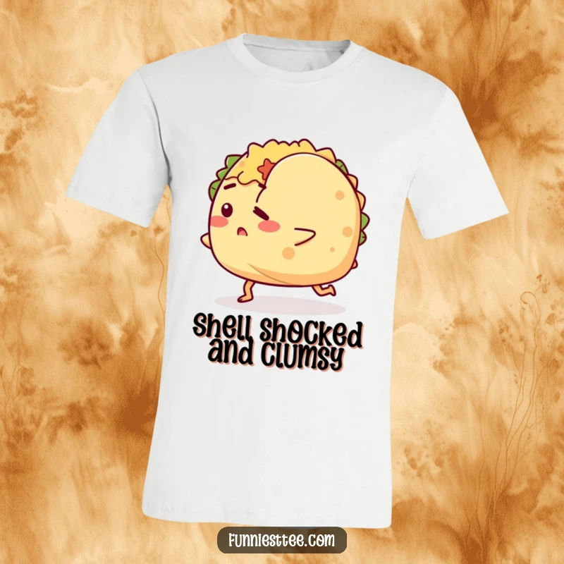 Funny t-shirt depicting a determined taco character with little legs hilariously tripping over its own shell, emphasizing a humorous struggle.