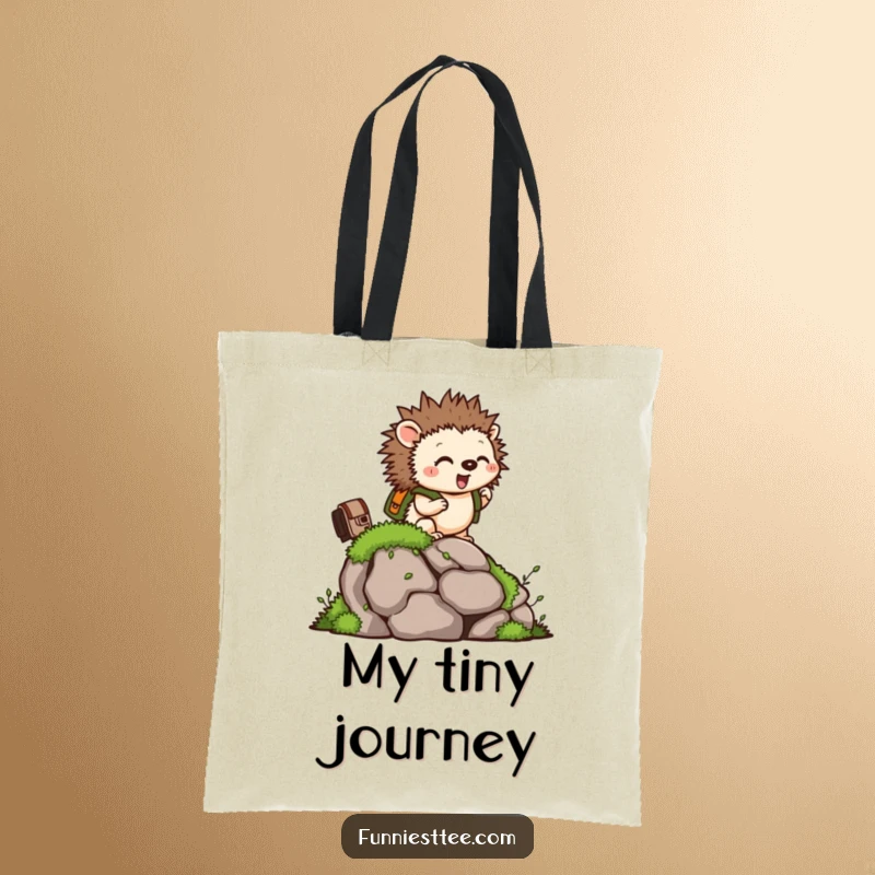 Funny tote bag with a tiny hedgehog wearing a backpack, climbing a mossy rock, perfect for carrying items.